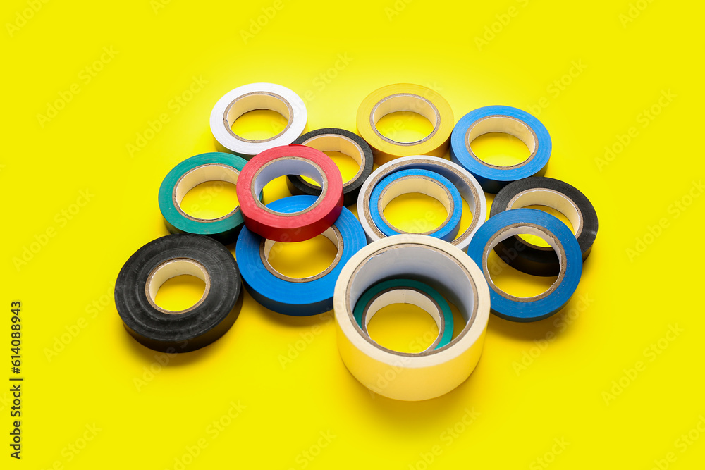 Adhesive tape rolls on yellow background