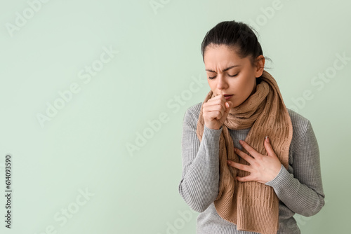 Ill young woman coughing on...