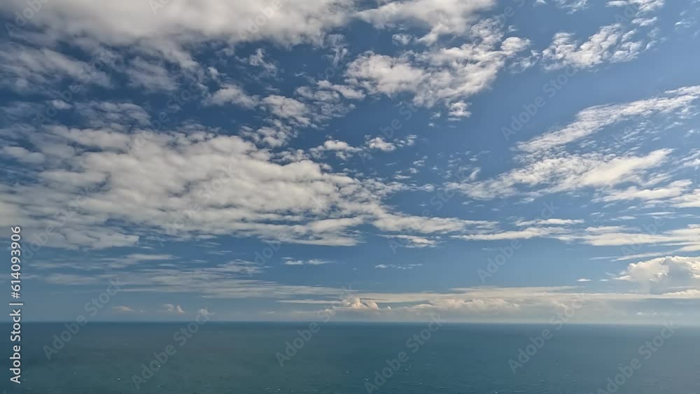 Timelapse fluffy Cumulus clouds moving in blue summer sky over calm sea. Abstract aerial nature summer ocean sunset, sea and sky view. Vacation, travel, holiday concept. Weather and Climate Change Timelapse fluffy Cumulus clouds moving in blue summer sky over calm sea. Abstract aerial nature summer ocean sunset, sea and sky view. Vacation, travel, holiday concept. Weather and Climate Change