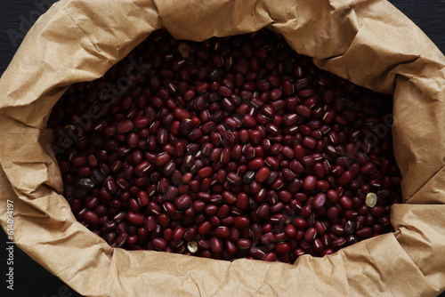 Photograph of adzuki beans in a brown paper bag