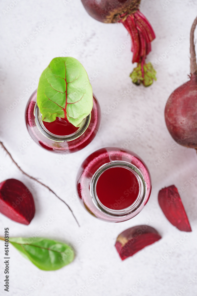 Bottles of fresh beetroot juice on light background Bottles of fresh beetroot juice on light background