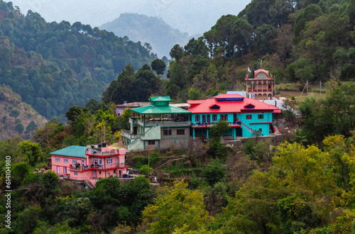 high angle shot of colorful houses on a hill with jungle in the background, nature concept.