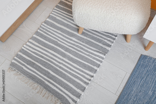 Bench and soft rug on floor in living room, closeup