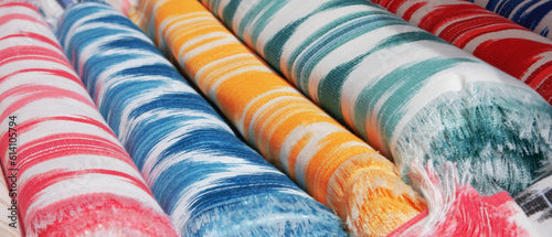 Collection of rolls of colorful fabrics in a typical mallorcan market. Banner