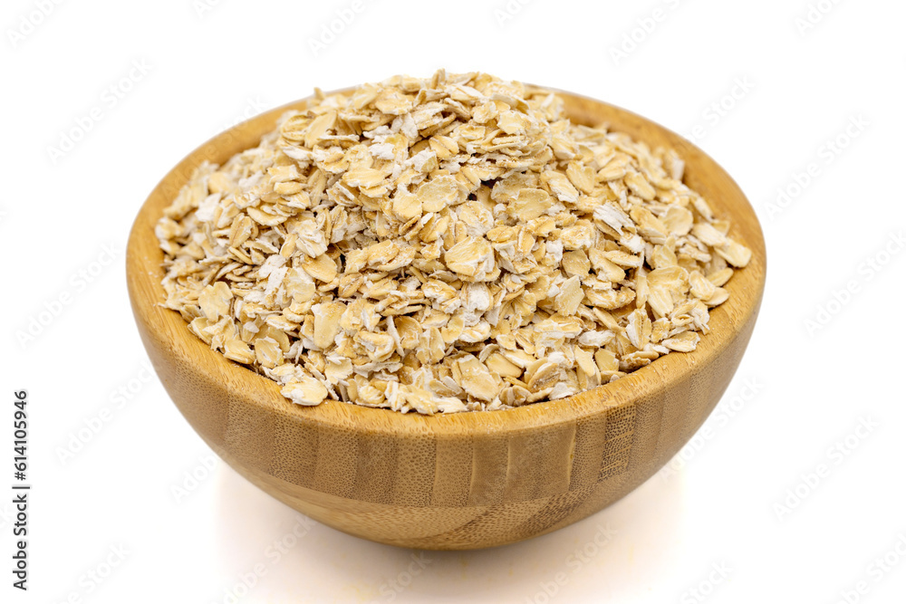 Oatmeal or Oat flakes isolated on white background. Oatmeal in wooden bowl. Close up Oatmeal or Oat flakes isolated on white background. Oatmeal in wooden bowl. Close up