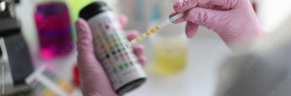 Chemist scientist holding ph test in hands closeup. Analysis in laboratory concept