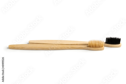 Different bamboo toothbrushes on white background