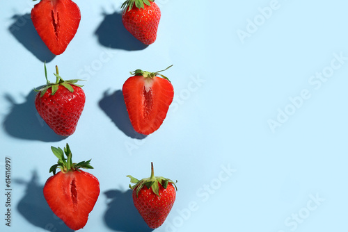 Many fresh strawberries on blue background