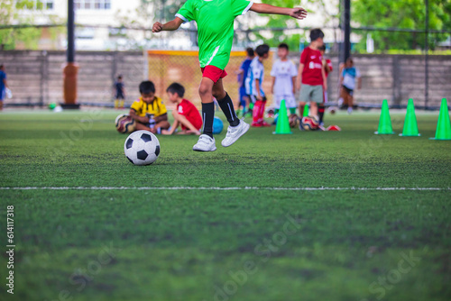 Fototapeta Naklejka Na Ścianę i Meble -  Soccer ball tactics children control the ball on a grass field for the training
