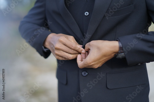 Men in slim black suit jackets. 