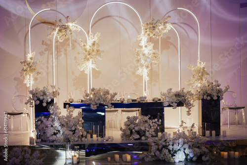 Obraz na płótnie Luxury elegant classic table for the bride and groom decorated with white flowers and vases with candles. w salonie