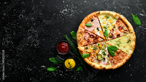 Pizza banner. Set of different pieces of pizza and ingredients on a black stone background. Top view. Pizza background.