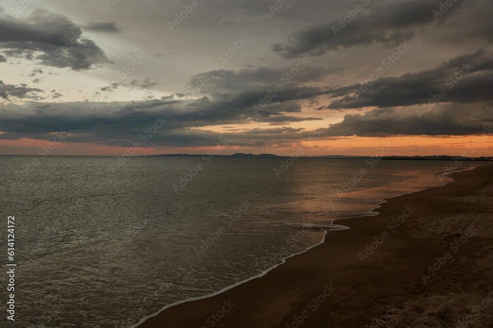 Tourists enjoy the sunset at Platja de La Rubina in Empuriabrava. Girona. Catalonia. Spain Tourists enjoy the sunset at Platja de La Rubina in Empuriabrava. Girona. Catalonia. Spain