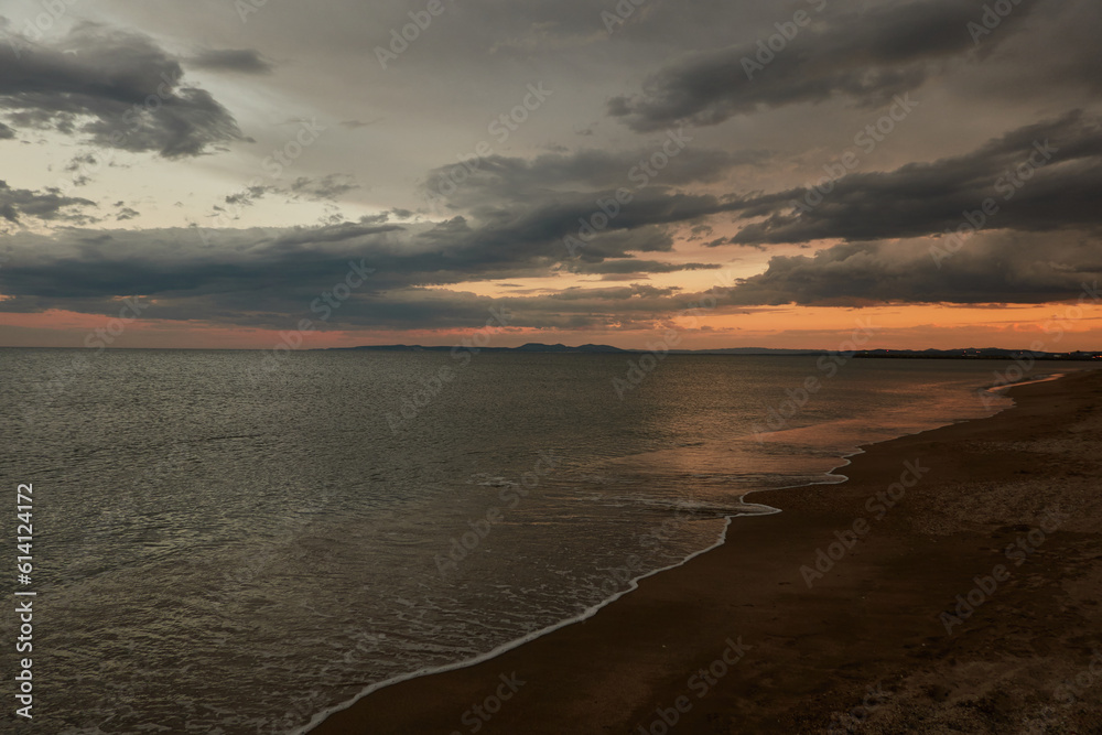 Tourists enjoy the sunset at Platja de La Rubina in Empuriabrava. Girona. Catalonia. Spain