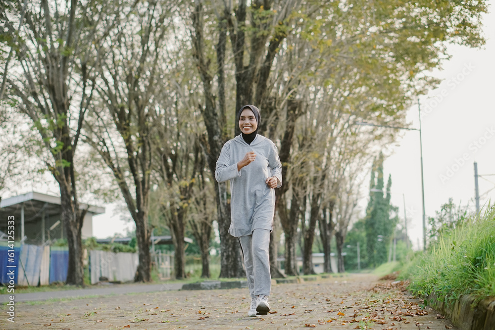 asian woman running and exercising outdoors excitedly asian woman running and exercising outdoors excitedly