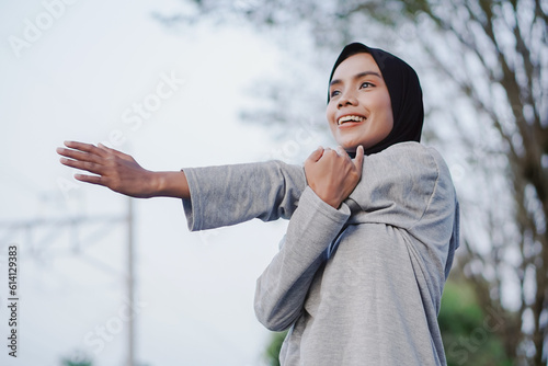 asian woman doing gymnastics and exercising outdoors excitedly