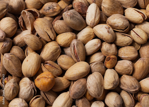 salted pistachios are on the table, a macro photograph of nuts