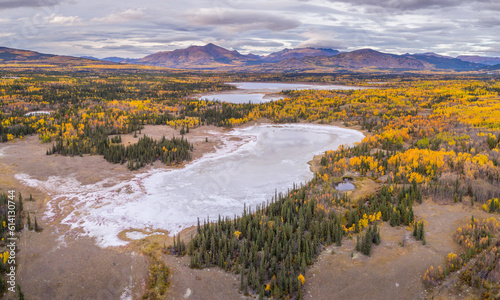 Aerial view on the Takhini Salt Flats with small lakes surrounded by boreal forests in fall colors, Yukon Territory Canada