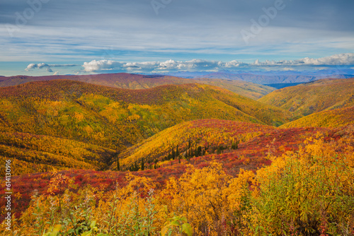 Landscape with mountains and rolling hills in spectacular autumn colors, Yukon territory Canada
