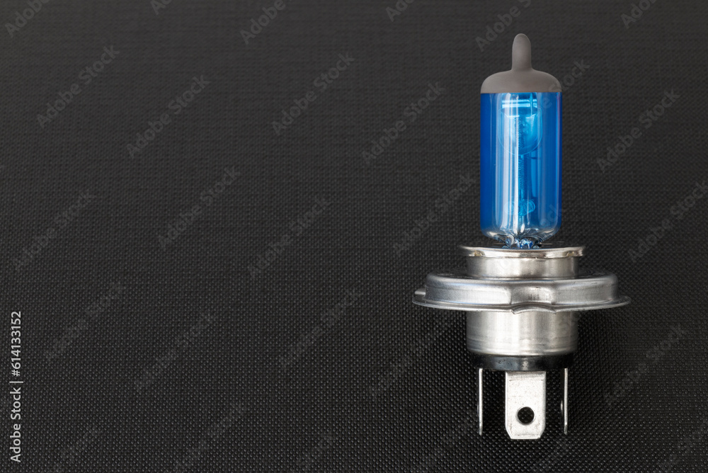 Halogen auto lamp, close-up of car headlight bulb on black background Halogen auto lamp, close-up of car headlight bulb on black background