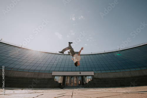 Parkour. Athlete performs tricks in the city. photo