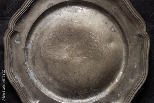 Close up of vintage pewter plate photo