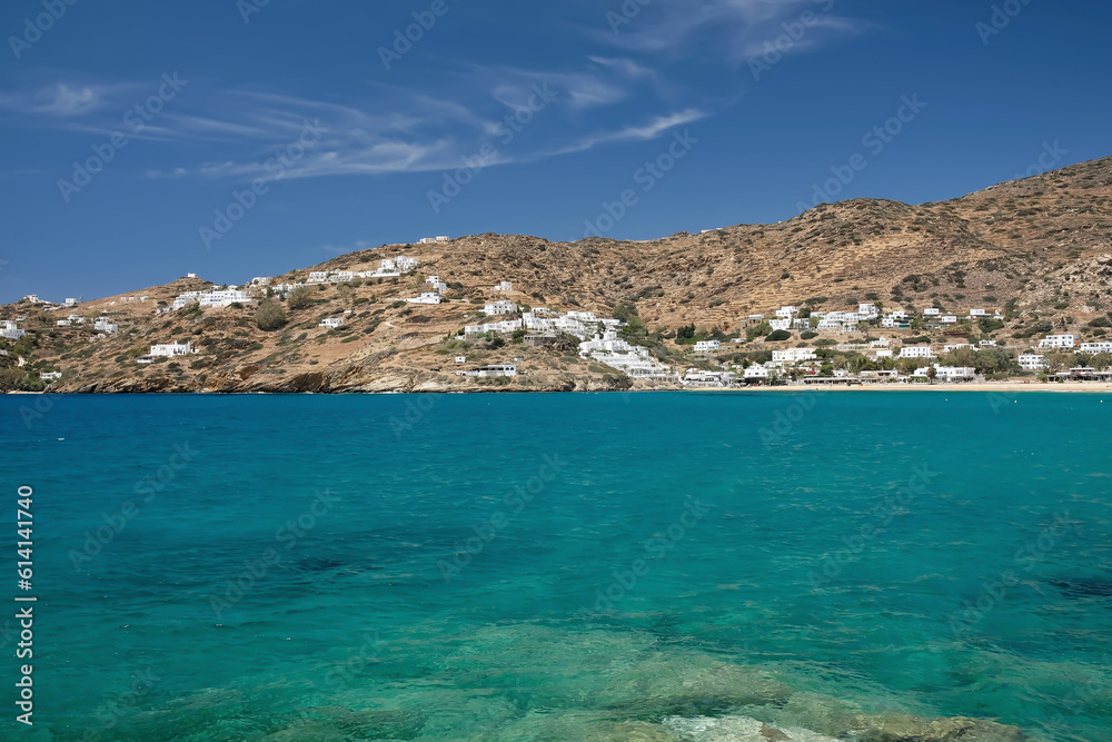 Whitewashed hotels and rooms to rent at the popular Mylopotas beach in Ios cyclades Greece and a beautiful blue sky