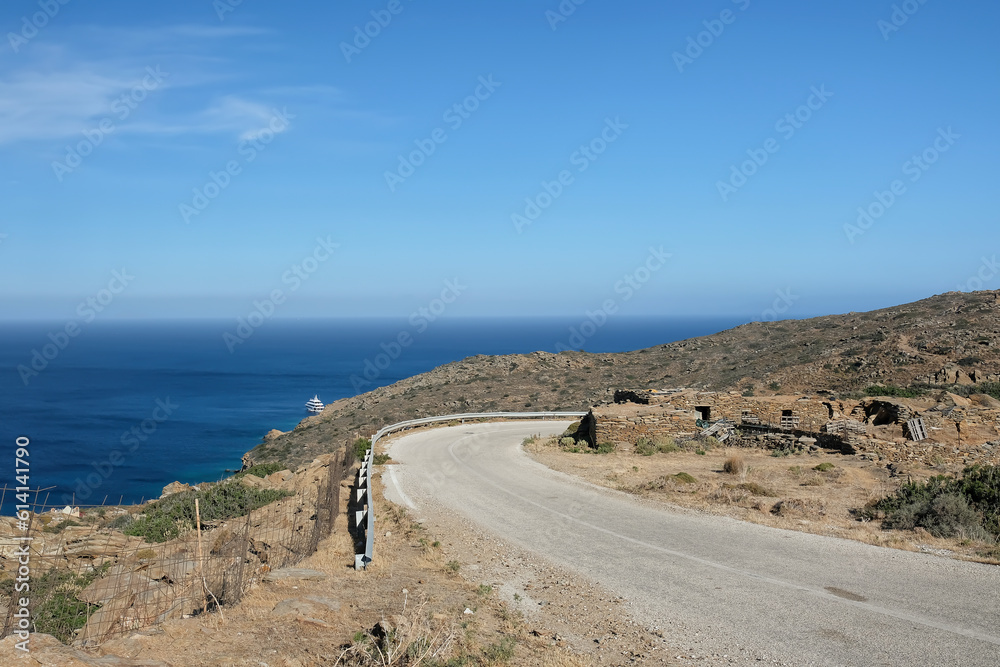 View of a lonely road next to the Aegean Sea in Ios Greece