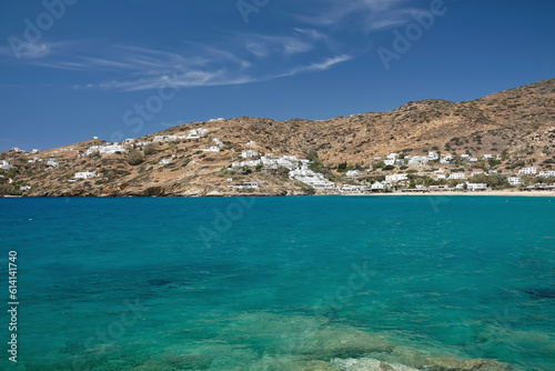 Whitewashed hotels and rooms to rent at the popular Mylopotas beach in Ios cyclades Greece and a beautiful blue sky