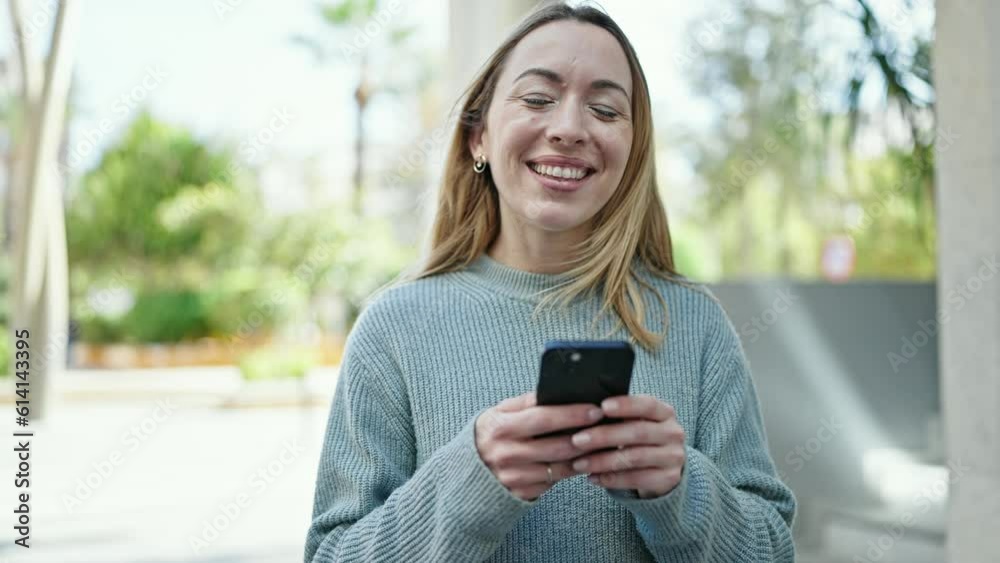 Young blonde woman smiling confident using smartphone at street Young blonde woman smiling confident using smartphone at street