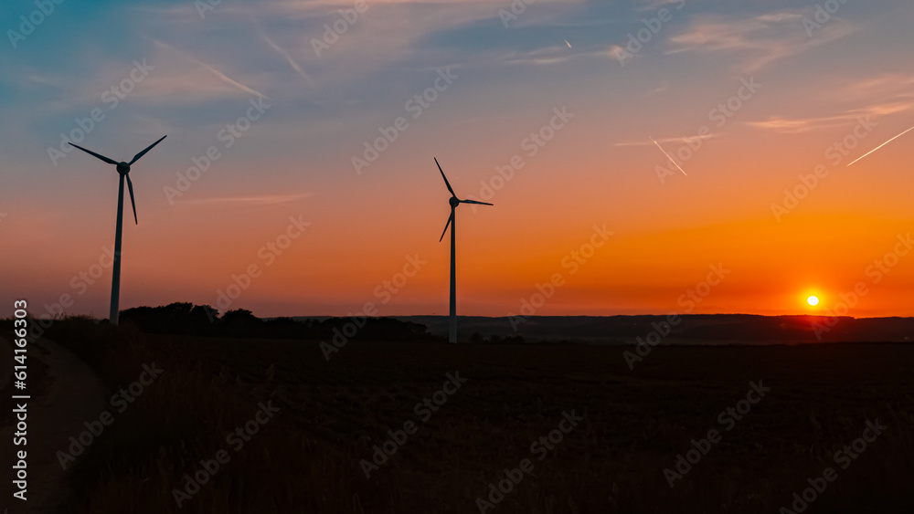 Fototapeta premium Sunset with wind power plant silhouettes near Kugl, Simbach, Dingolfing-Landau, Bavaria, Germany