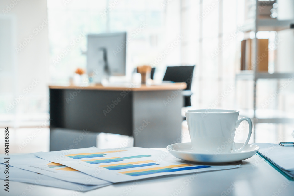 Coffee cup on office table with background of modern office. Coffee