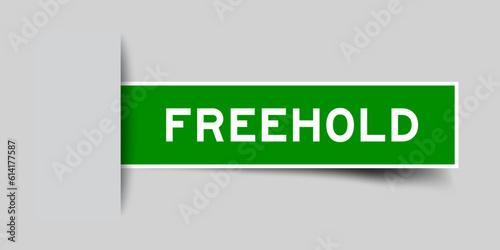 Green color square label sticker with word freehold that inserted in gray background