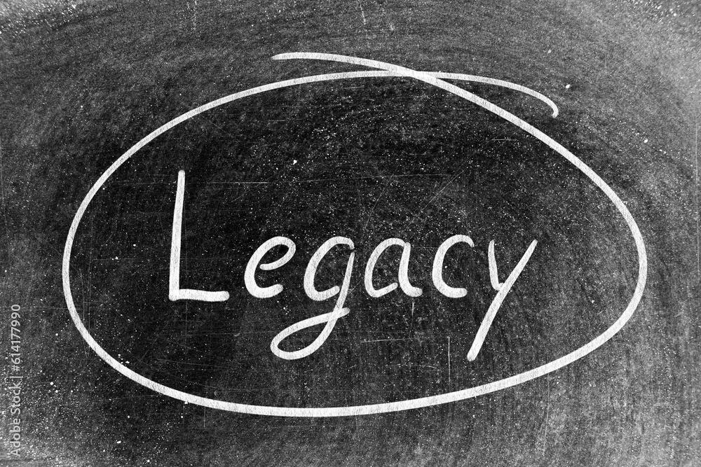 White chalk hand writing in word legacy and circle shape on blackboard background White chalk hand writing in word legacy and circle shape on blackboard background
