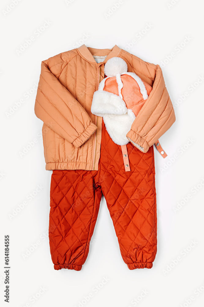 Terracotta autumn jacket with warm pants, hat on white background. Stylish set of baby clothes for autumn or winter. Fashion kids outfit. Terracotta autumn jacket with warm pants, hat on white background. Stylish set of baby clothes for autumn or winter. Fashion kids outfit.