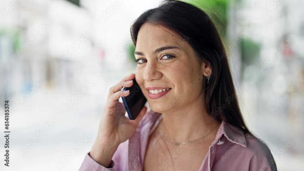 Young beautiful hispanic woman smiling confident talking on the smartphone at street Young beautiful hispanic woman smiling confident talking on the smartphone at street