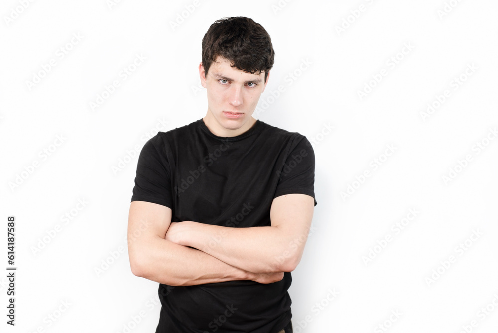 Young sad guy on light background in a dark t-shirt, suffering from anxiety and headache, stressed from studying at college, does not understand why he is studying there Young sad guy on light background in a dark t-shirt, suffering from anxiety and headache, stressed from studying at college, does not understand why he is studying there