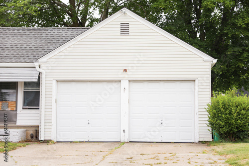A closed garage door, symbolizing privacy, security, and a barrier between the outside world and personal space © Your Hand Please