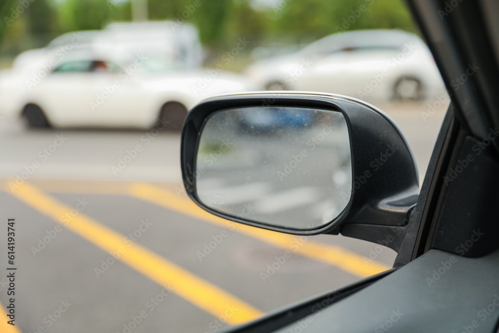 A car mirror reflects life's perspectives and symbolizes self-reflection, awareness, and the ability to navigate choices and directions with clarity