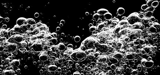 Soda water bubbles splashing underwater against black background. Cola liquid texture that fizzing and floating up to surface like a explosion in under water for refreshing carbonate drink concept.