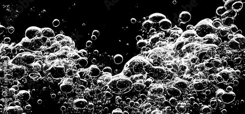 Soda water bubbles splashing underwater against black background. Cola liquid texture that fizzing and floating up to surface like a explosion in under water for refreshing carbonate drink concept.