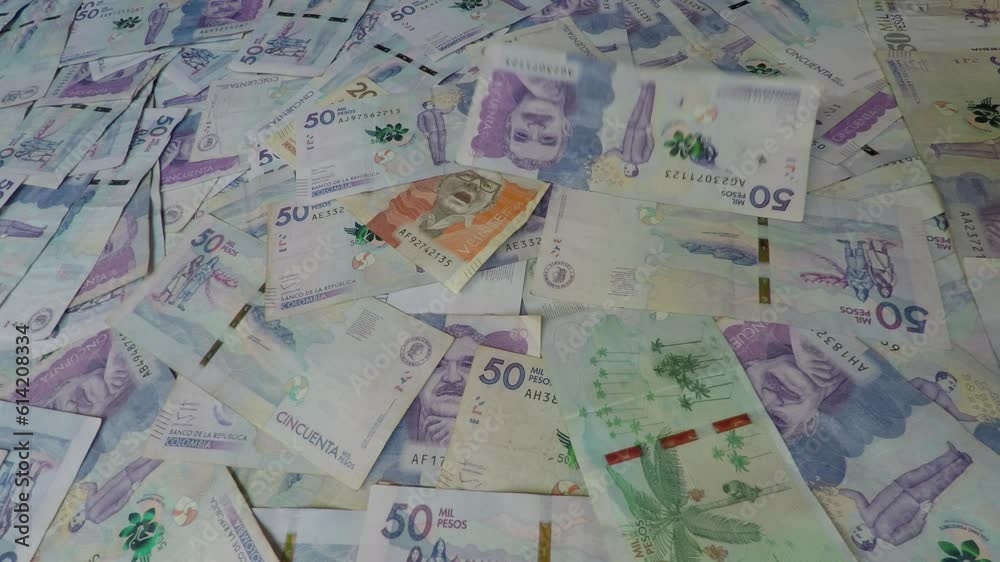 Colombian Peso - Cash, banknotes, bills falling on a pile of notes, currency of Colombia Colombian Peso - Cash, banknotes, bills falling on a pile of notes, currency of Colombia