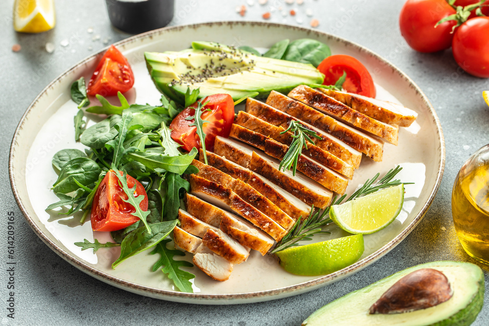Fresh green salad with grilled chicken fillet, tomatoes, avocado, lemon on light background. Diet Concept. Top view copy space Fresh green salad with grilled chicken fillet, tomatoes, avocado, lemon on light background. Diet Concept. Top view copy space