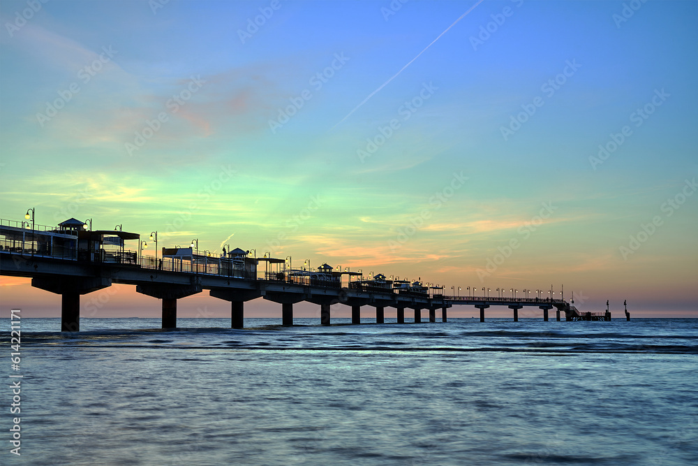 Obraz premium Concrete pier in the evening by the Baltic Sea in Miedzyzdroje, Poland