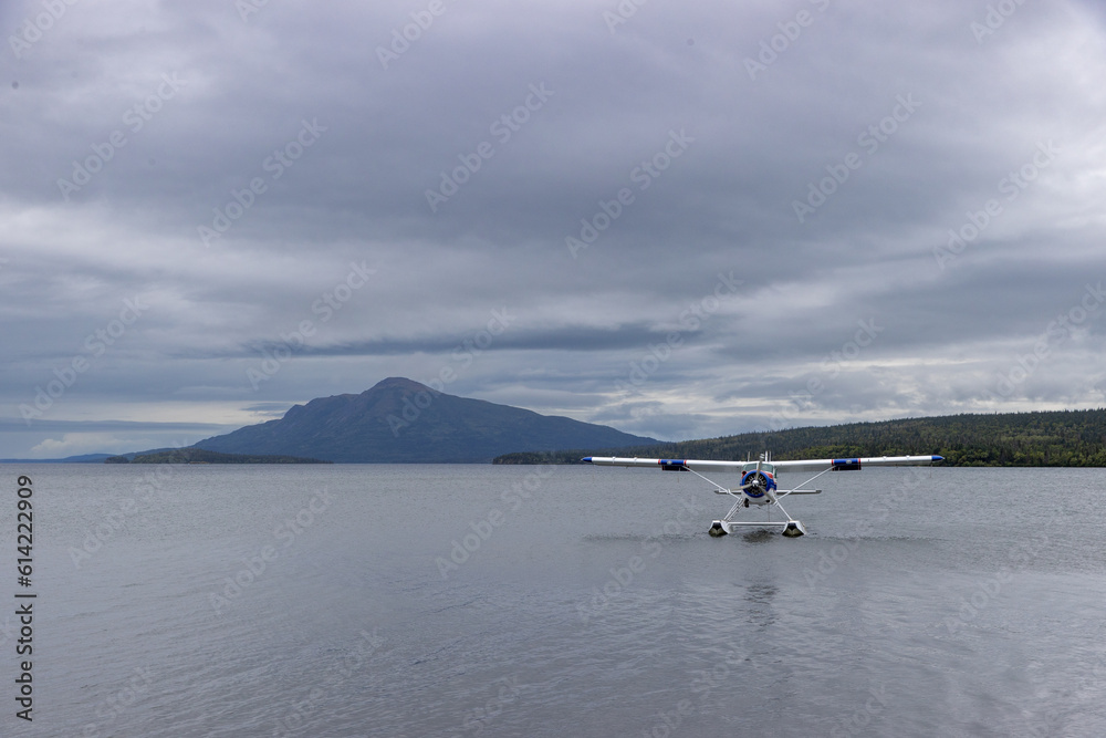 Fototapeta premium Small bush plane on a pretty lake in Alaska. Adventure travel through wilderness.