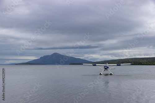 Small bush plane on a pretty lake in Alaska. Adventure travel through wilderness.