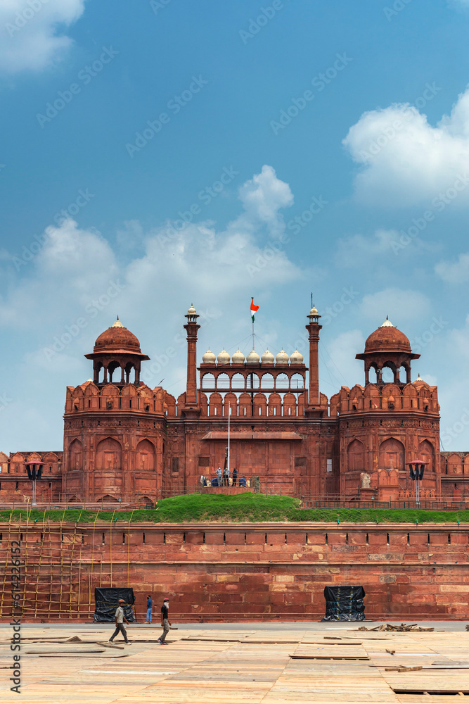 Red Fort or Lal Qila in Delhi with indian flag on foreground with moody sk.UNESCO World heritage site. Discover the India. Open world after covid-19