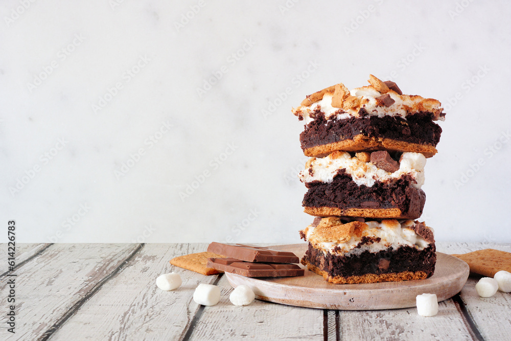 Fototapeta premium Stack of smores brownie dessert bars. Side view table scene with a white background.