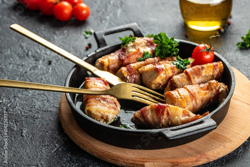 Baked chicken breast wrapped in bacon on a cast-iron frying pan. Concept healthy and balanced eating. place for text, top view