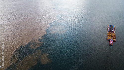 Water Confluence Between Tapajós and Amazon River in Brazil, Aerial Drone Fly Above Clearwater Source Stream photo